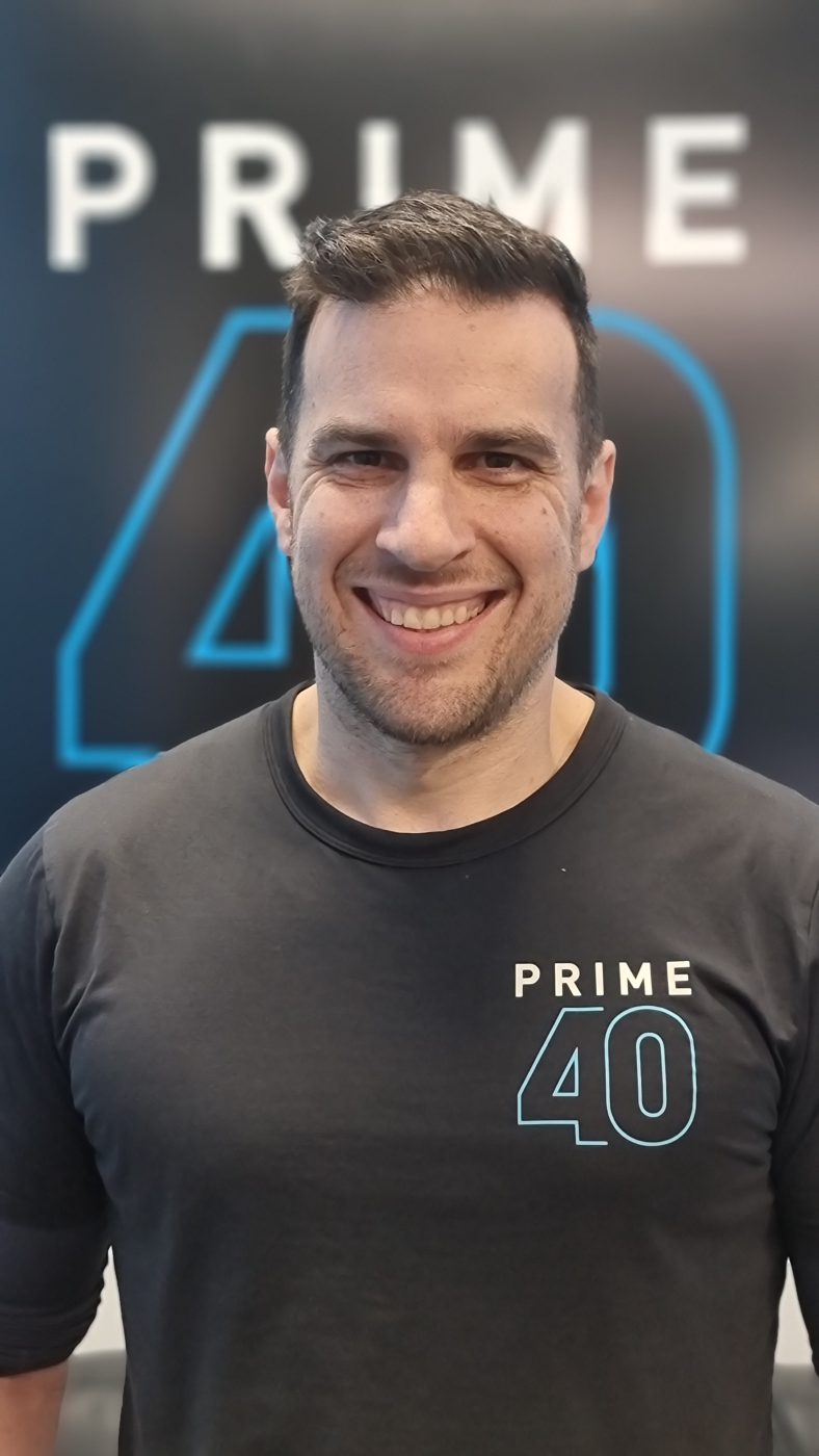 Good looking man wearing a gray shirt with the Prime 40 logo on it